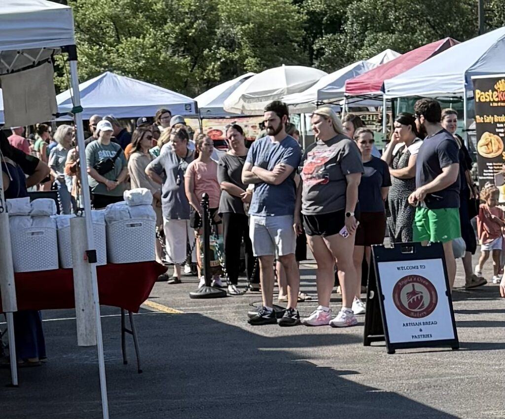 People waiting in line for artisan bread at The Woodlands Farmers Market